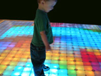 Kid on lighted LED dance floor